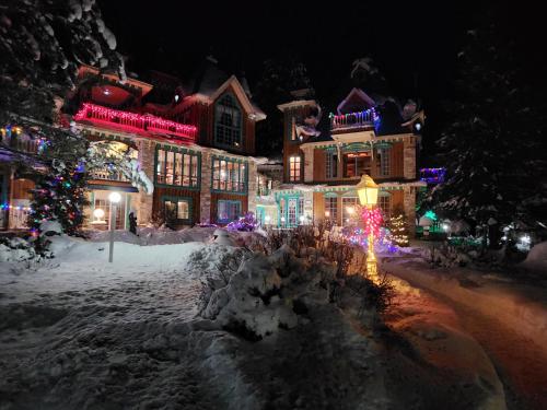 a town with christmas lights in the snow at Domaine Rivière Sacacomie in Saint-Alexis-des-Monts