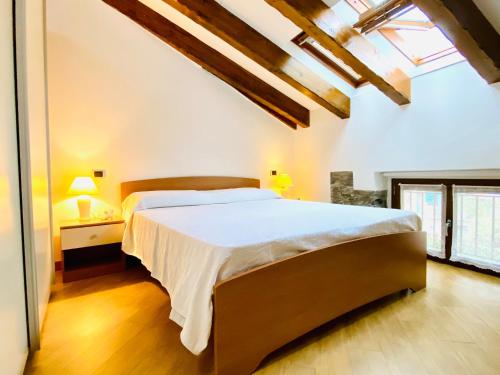 a bedroom with a large bed in a room at ANGELO Loft in Tremezzo