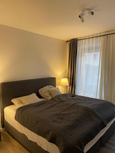 a bedroom with a large bed with a window at Strandstrasse34 in Laboe