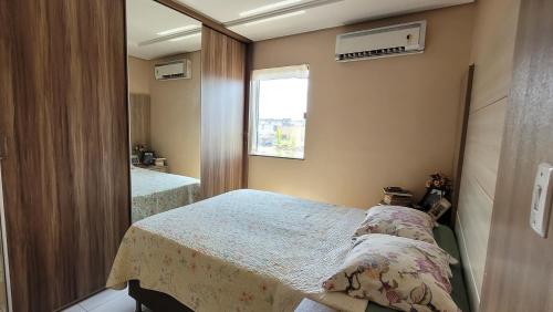 a bedroom with two beds and a mirror at Apartamento no centro de Santarém-PA in Santarém