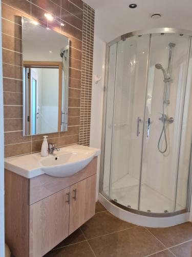 a bathroom with a sink and a shower at Sea Breeze in Żebbuġ