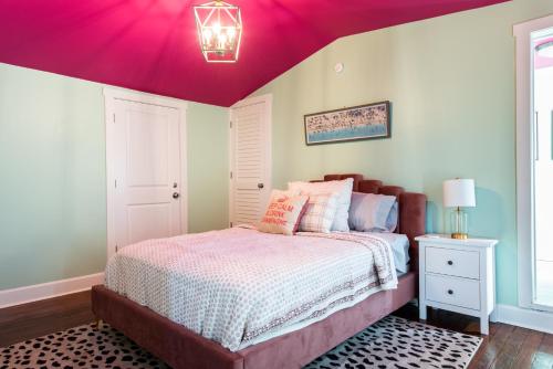 a bedroom with a bed with a purple ceiling at Juleps And Lilies Germantown 1 Bedroom Apartment in Louisville