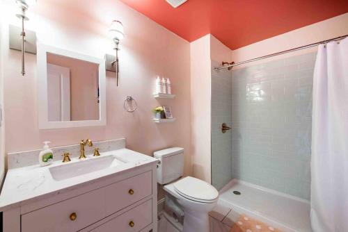 a bathroom with a sink and a toilet and a shower at Blush And Bashful Germantown Two Bedroom Apartment in Louisville
