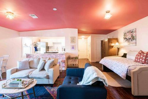 a living room with a bed and a couch at Blush And Bashful Germantown Two Bedroom Apartment in Louisville