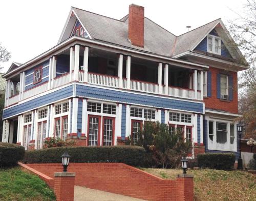 a large red and blue house with a brick wall at 2439 Fairfield "A Bed and Breakfast" in Shreveport