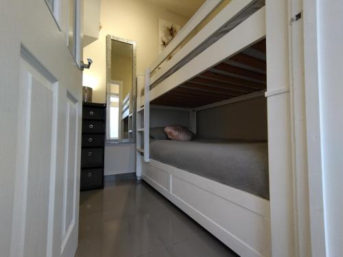 a bedroom with a bunk bed in a room at Queens Holiday Basement in Pembroke Dock