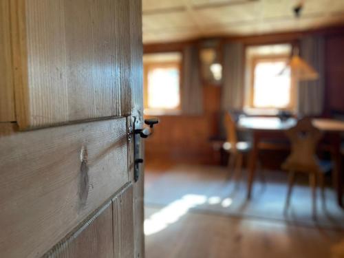a wooden door in a room with a table at Hof Ida in Bach