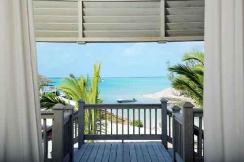 a balcony with a view of the beach at Sand Dollar Cottage cottage in Rock Sound