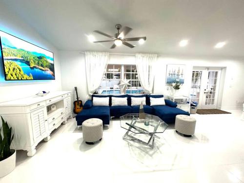 a living room with a blue couch and a table at Home in Miami in Miami