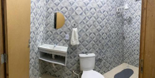 a bathroom with a white toilet and a sink at Pousada vida nos lençóis in Barreirinhas