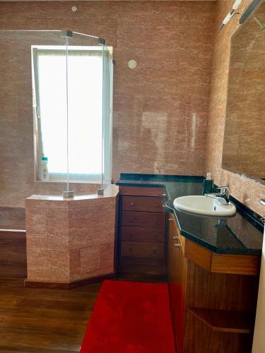 a bathroom with a sink and a tub with a window at Estoril dream in Estoril