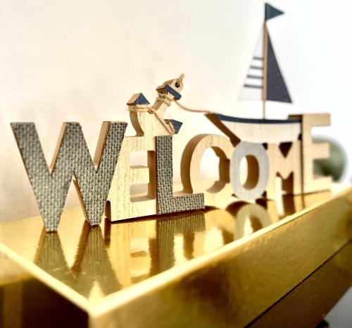 a wooden sign with the word win over in front at Duplex Sea View by Albufeira Holidays in Albufeira