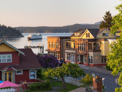 a row of houses with a boat in the water at The Web Suites in Friday Harbor
