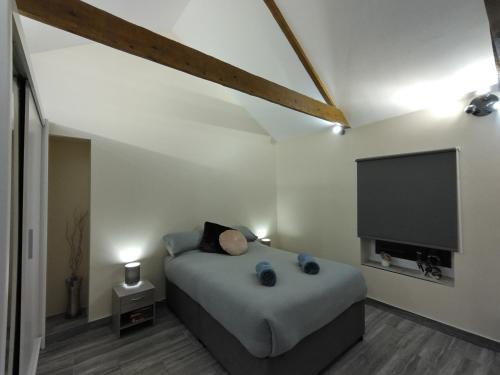 a bedroom with a bed and a flat screen tv at Queens Holiday Apartment in Pembroke Dock