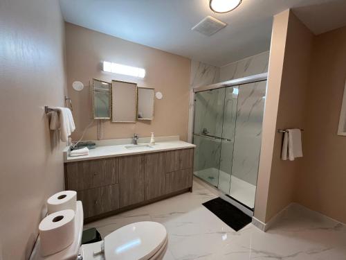 a bathroom with a shower and a toilet and a sink at Vancouver shaughnessy guest home in Vancouver