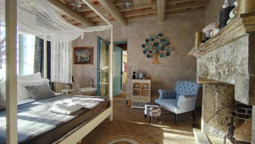 a bedroom with a large bed and a fireplace at Podere Le Vedute in Larciano