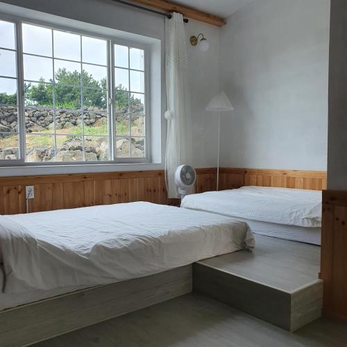 Llit o llits en una habitació de Jeju Damda