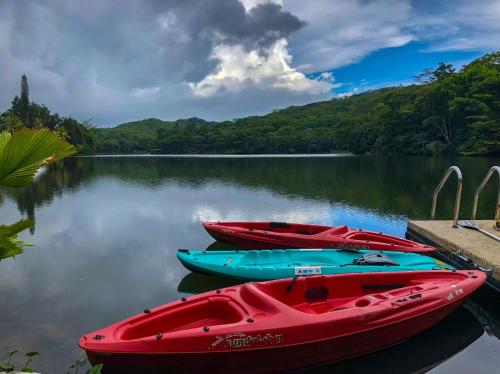three boats are docked at a dock on a lake at Cabañas Lago Cerro Azul - Lake of Panama in Cerro Azul