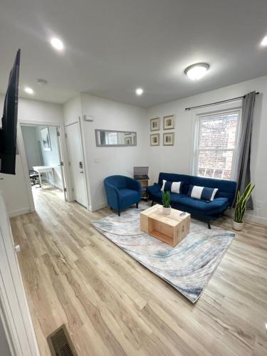 a living room with a blue couch and a table at Modern Luxury Apartment near NYC in Jersey City