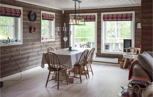 a dining room with a table and chairs and windows at 4 Bedroom Pet Friendly Home In Eggedal in Eggedal
