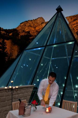 a man in a yellow tie sitting at a table at Val di Luce SPA Resort in Abetone