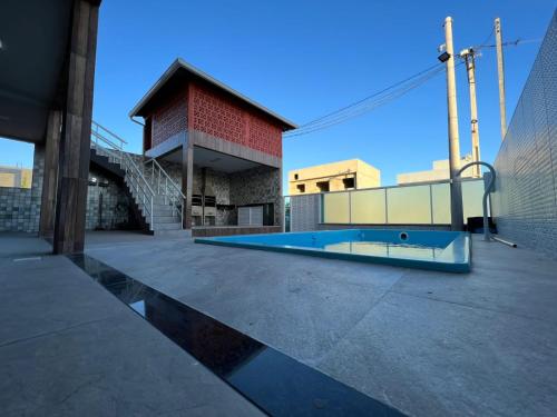 a building with a swimming pool in front of a building at Águas Rasas - Flats in Arraial do Cabo