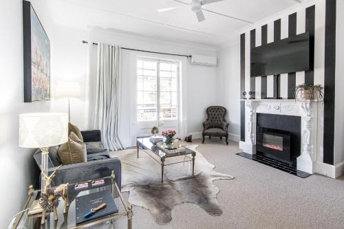 a living room with a fireplace and a tv at 70 On Mortimer in Mudgee