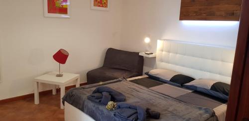 um pequeno quarto com uma cama e um sofá em Attico Teatro Greco em Catânia