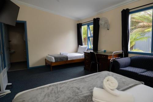 a hotel room with two beds and a chair at Tullah Lakeside Lodge in Tullah