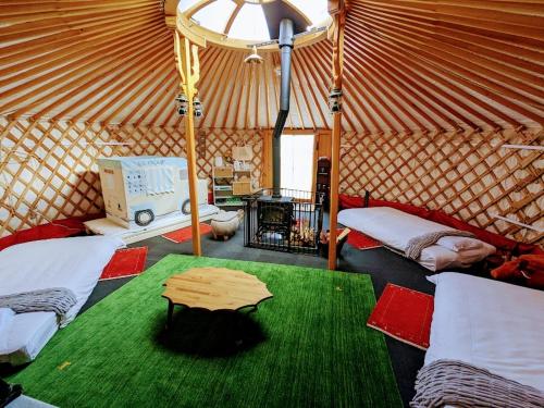 a yurt with two beds and a table in it at Family Hotel Matsumoto Satoyama Doors in Matsumoto