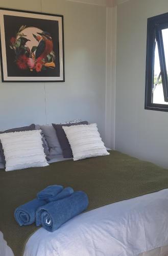 a bedroom with a large bed with towels on it at The Morgans in Waiau
