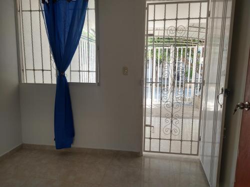 una puerta con una cortina azul y una puerta en Habitación doble cómoda en Valledupar