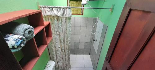 a bathroom with a shower with a shower curtain at La casa de tia in Monteverde Costa Rica