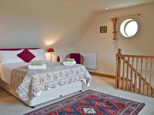 a bedroom with a bed with a rug on the floor at Sunrise in Coughton