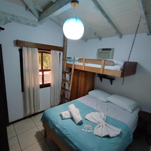 Ένα ή περισσότερα κρεβάτια σε δωμάτιο στο Hotel Chácara das Flores