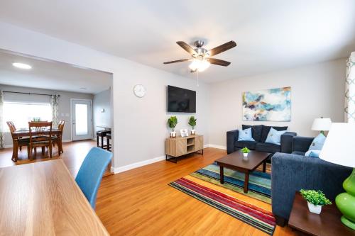 a living room with a blue couch and a table at Roomy 3BR 2 Bath minutes to Uptown and Airport Ideal for small families in Charlotte