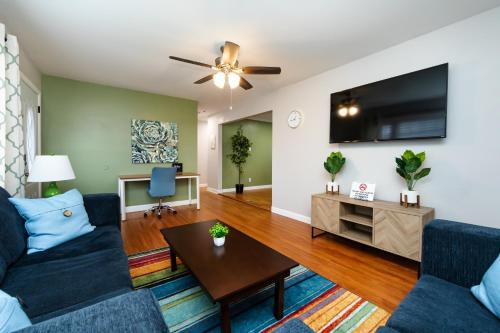 a living room with a couch and a tv at Roomy 3BR 2 Bath minutes to Uptown and Airport Ideal for small families in Charlotte