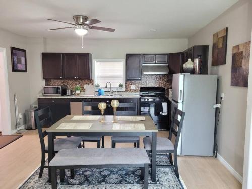 a kitchen with a table with chairs and a refrigerator at No Chores, 10min to downtown and 25min to Niagara Falls in Buffalo