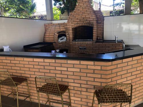a brick bar with chairs and a brick oven at Chácara/ Rancho Família Campos in Bicanca