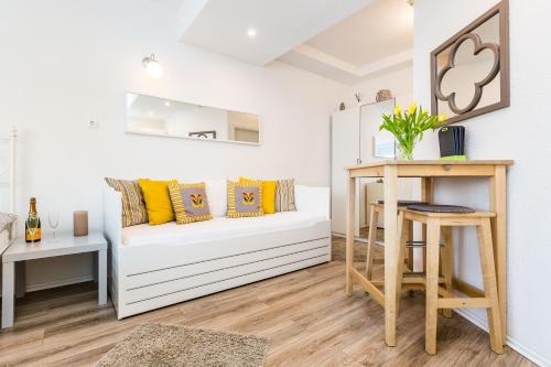 a living room with a white couch and a table at Apartment Cologne in Cologne