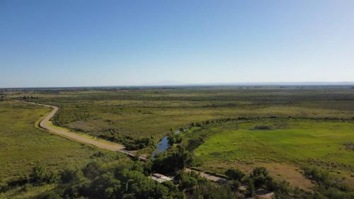 an aerial view of a field with a river at CABAÑAS LA PILARICA in San Rafael