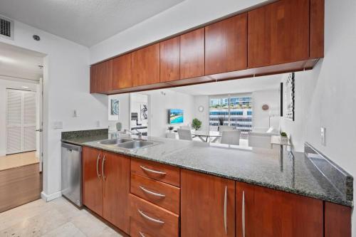 a kitchen with wooden cabinets and a counter top at Superb unit, centrally located with parking in Miami