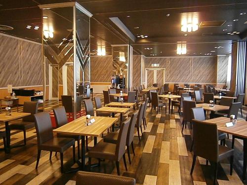 a dining room with wooden tables and chairs at The Celecton Takamatsu in Takamatsu