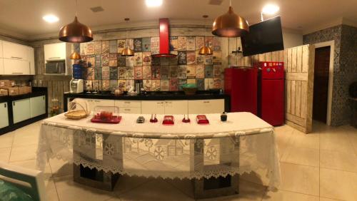 a kitchen with a table in the middle of a room at Pousada Mineira SJB in São João da Barra