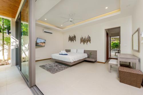 a bedroom in a villa with a bed at Laem Ka Residence by Tropiclook in Rawai Beach