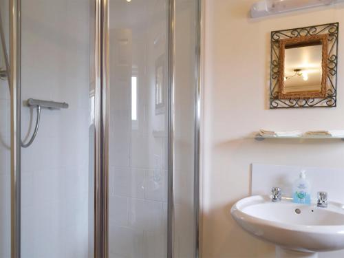 a bathroom with a shower and a sink at Moorings House in Fritton Norfolk