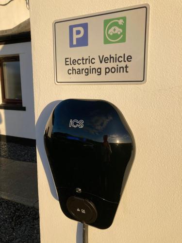 a sign for an electric vehicle charging point on a wall at Kentraw Farmhouse Luxury Self Catering in Bruichladdich