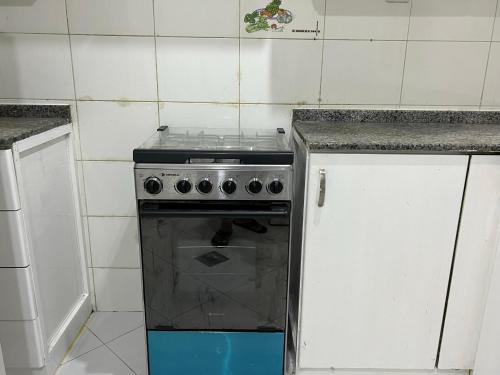 a kitchen with a stove and a counter top at Welcom Tourist Hostel in Dubai