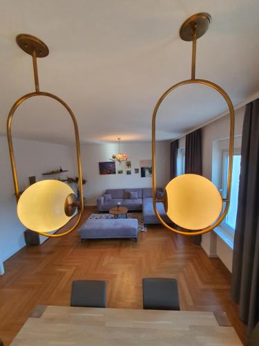 a living room with two large chandeliers at Sarajevo City Soul Apartment in Sarajevo
