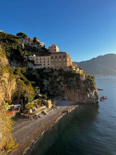 a building on the side of a mountain next to the water at Casa Angelica in Ravello